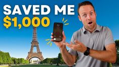 a man holding up his cell phone in front of the eiffel tower with $ 1, 000