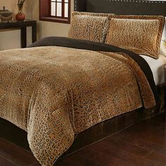 a leopard print comforter set on a bed