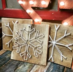 two wooden snowflakes are sitting on the table