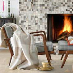 a chair with a blanket on it next to a fire place