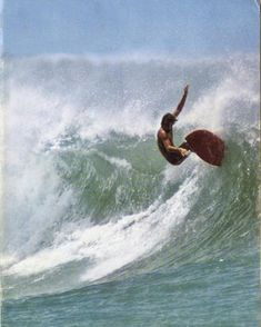 a man riding a wave on top of a surfboard