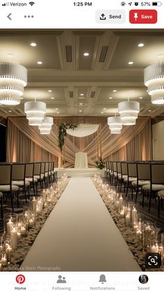 an image of a wedding setup with candles on the aisle