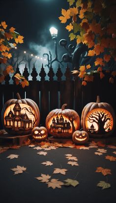 three carved pumpkins sitting on top of a table