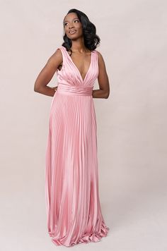 a woman in a pink dress posing for the camera