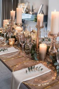 a table set with candles and place settings