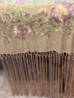 this antique 1900s piano shawl beautifully different as it is embroidered with a unique pale lavender, gold and green on a pale cream/gold silk background. Measuring 16" long, the fringed border is also very impressive, but there is some very minor tangling. Measuring 50 1/2" square (not including the fringe), this antique Chinese Embroidered shawl is in very good condition, and it is double-sided with Floral Silk Embroidery. This Shawl came from an estate sale Vintage Wedding Shawl With Traditional Drape, Vintage Shawl With Traditional Drape For Wedding, Vintage Silk Dupatta, Bohemian Beige Shawl With Intricate Embroidery, Embroidered Silk Shawl, Beige Bohemian Shawl With Intricate Embroidery, Embroidered Beige Pashmina Shawl, Beige Embroidered Pashmina Shawl, Velvet Shawls Embroidery Silk