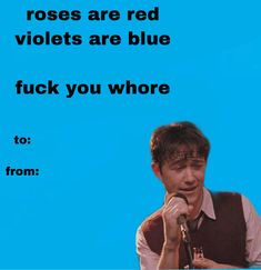 a man holding a microphone in front of a blue background with the words roses are red violets are blue