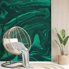 a chair and rug in front of a wall with green marbled paint on it