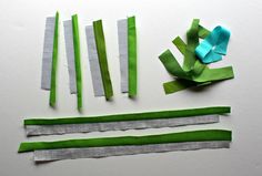 several pieces of green paper cut into strips