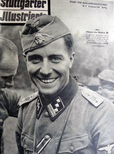 an old photo of a man in uniform smiling at another man with his hand on his hip