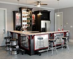 a bar with stools in the middle of it