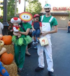 some people are dressed up as mario and luigi