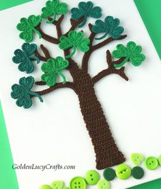 a crocheted card with a tree made out of green buttons and button holes