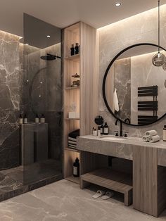 a bathroom with marble walls and flooring has a large round mirror on the wall