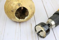 a close up of an object on a wooden surface with a screwdriver next to it