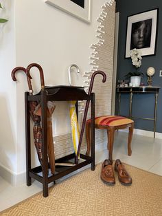 a pair of shoes and umbrellas are sitting on the floor in front of an entryway