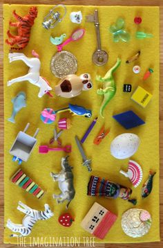 there are many different toys on the yellow table cloth, including keys and magnets