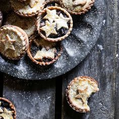 several small pies on a plate with sugar sprinkles around the edges