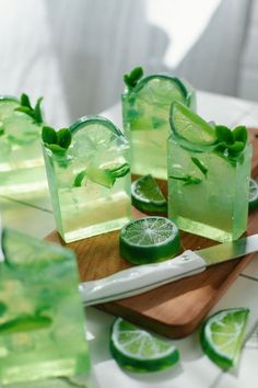 limeade pops are on a cutting board with slices of lime