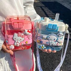 two children's water bottles in the shape of hello kitty bags, one pink and one blue