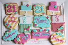 decorated cookies are arranged in the shape of numbers and birthday cakes for someone's 21st birthday