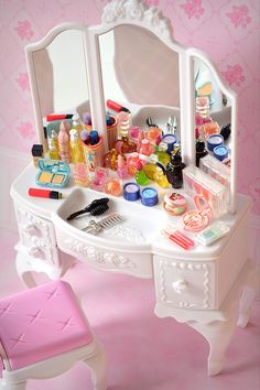 a white vanity with lots of cosmetics on it