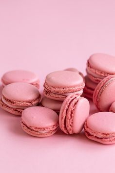 several pink macaroons on a pink background