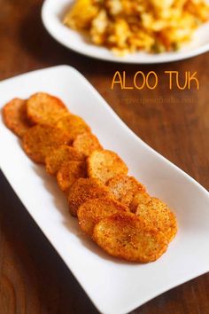 two white plates with food on them and the words aloo tuk above it