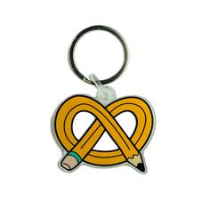 a pencil is in the middle of a heart shaped keychain