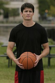 a man holding a basketball in his hands