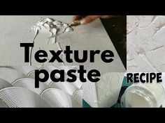 the texture pastee is being applied to create a textured wallpaper effect with white paint