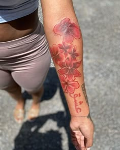 a woman with a flower tattoo on her arm