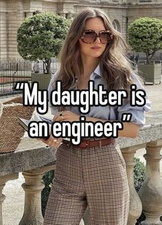 a woman in plaid pants holding a cell phone with the caption'my daughter is an engineer '