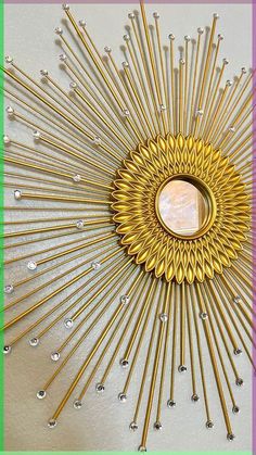 a gold sunburst is hanging on the wall