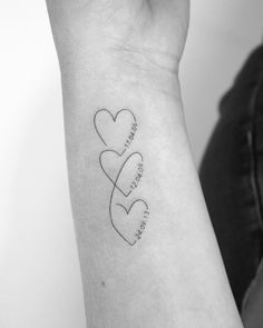 a woman's arm with two hearts on it