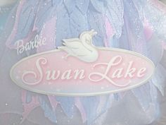 there is a swan lake sign on the back of a stuffed animal toy in this photo