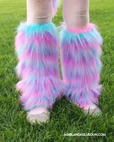 the legs and feet of a person wearing furry boots with blue, pink and purple fur