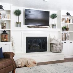 a living room filled with furniture and a flat screen tv mounted above a fire place