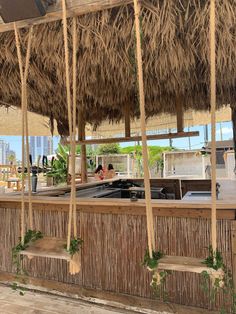 an outdoor bar with thatched umbrellas on the roof