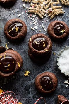 chocolate cookies and candy canes on a table with snowflakes in the background