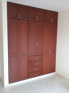 an empty room with cabinets and tile flooring on the ground in front of it