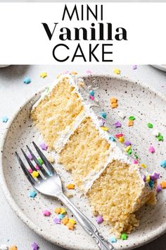 a white plate topped with a slice of cake and sprinkles next to a fork