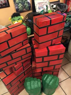 some red and green bricks stacked on top of each other in the middle of a room