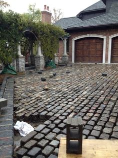 a large brick driveway in front of a house