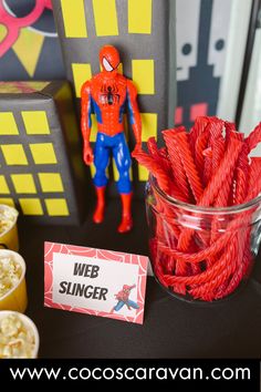 a spiderman themed party with candy sticks