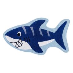 a blue and white shark shaped rug with an open mouth on it's side