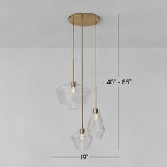 three clear glass pendants hanging from a ceiling fixture with measurements for the length and height