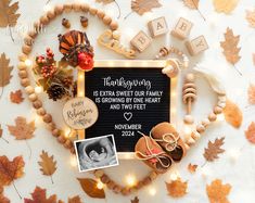 a baby announcement surrounded by autumn leaves