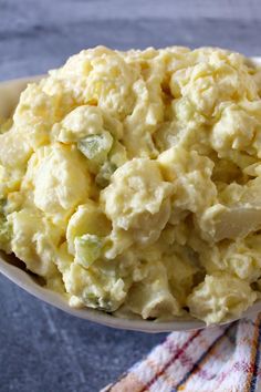 a white bowl filled with mashed potatoes on top of a table