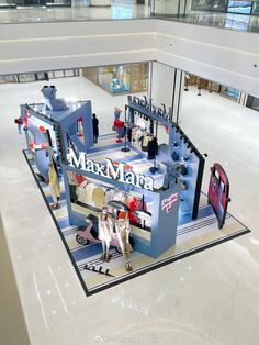 a display in the middle of a mall filled with mannequins and other items